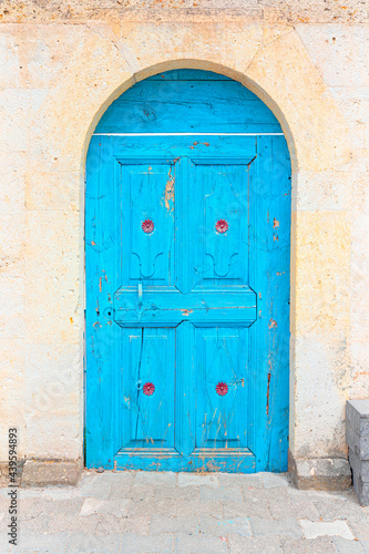 Ancient wooden door on a stone made wall - Mustafapasa, Cappadocia © muratart