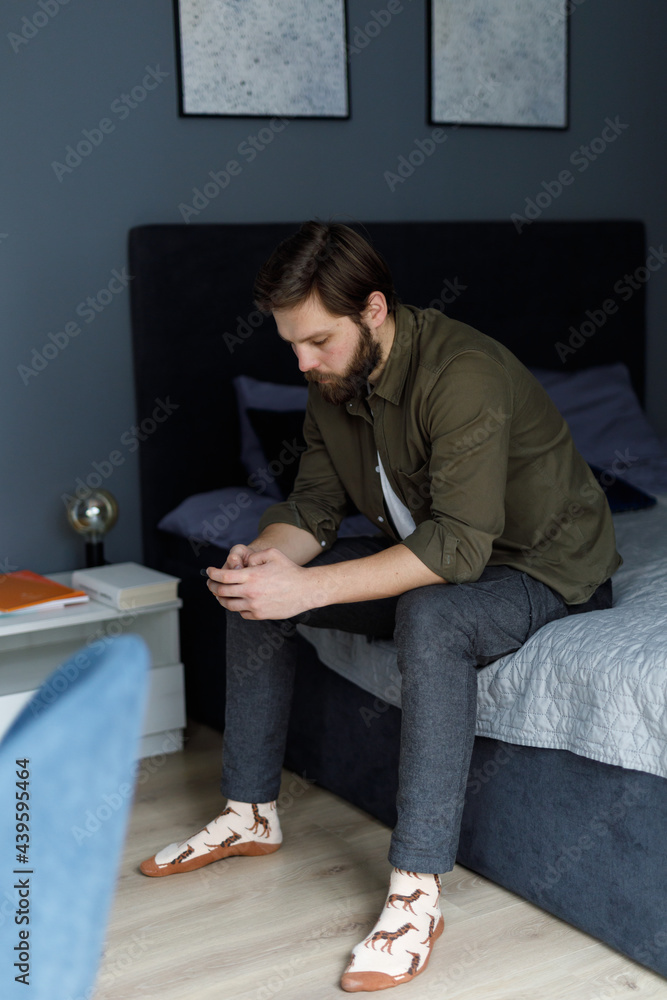Upset man in bedroom Upset man in bedroom