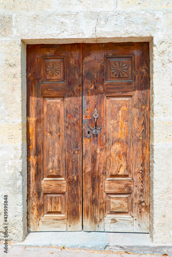 Ancient wooden door on a stone made wall - Mustafapasa, Cappadocia