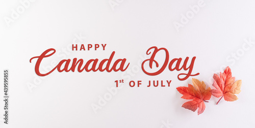 Happy Canada Day; sign and symbol concept made from red silk maple leaves on white background with the text.