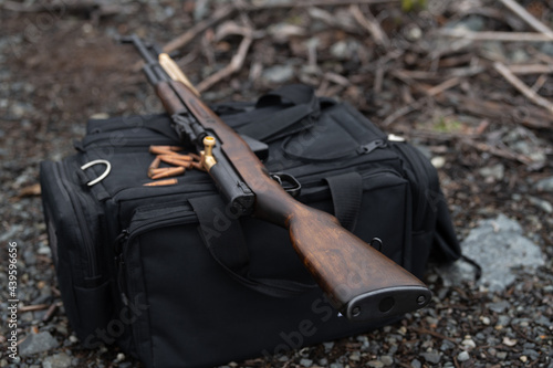SKS Rifle on shooter's bag – wide depth of field alt angle photo
