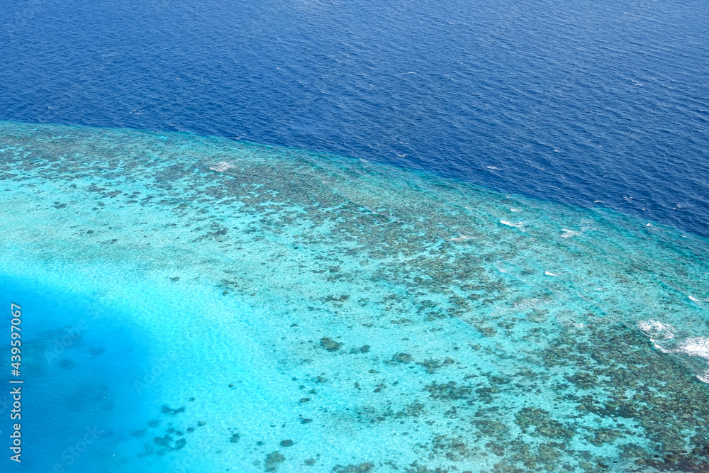 Overlooking the beautiful blue coral atoll of the Maldives in the Indian Ocean