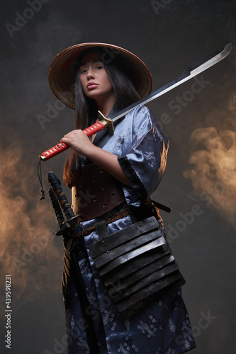 Japanese woman assassin with bamboo hat and katana