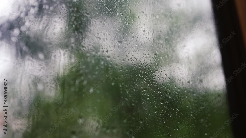 drops of water on the window. camera movement along wet glass on a rainy day drops of water on the window. camera movement along wet glass on a rainy day