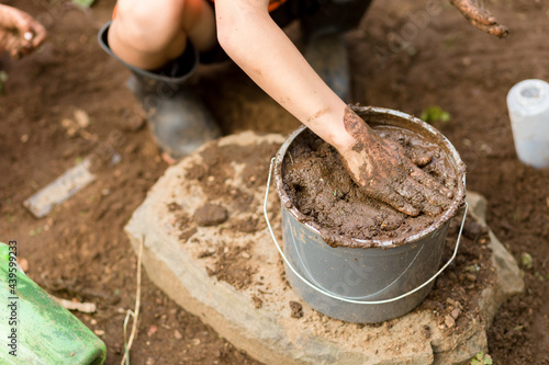 Wallpaper Mural Child pat bucket of mud Torontodigital.ca