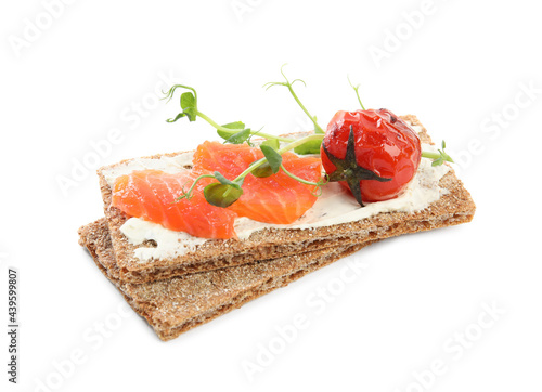 Fresh rye crispbreads with salmon, cream cheese and grilled tomato on white background