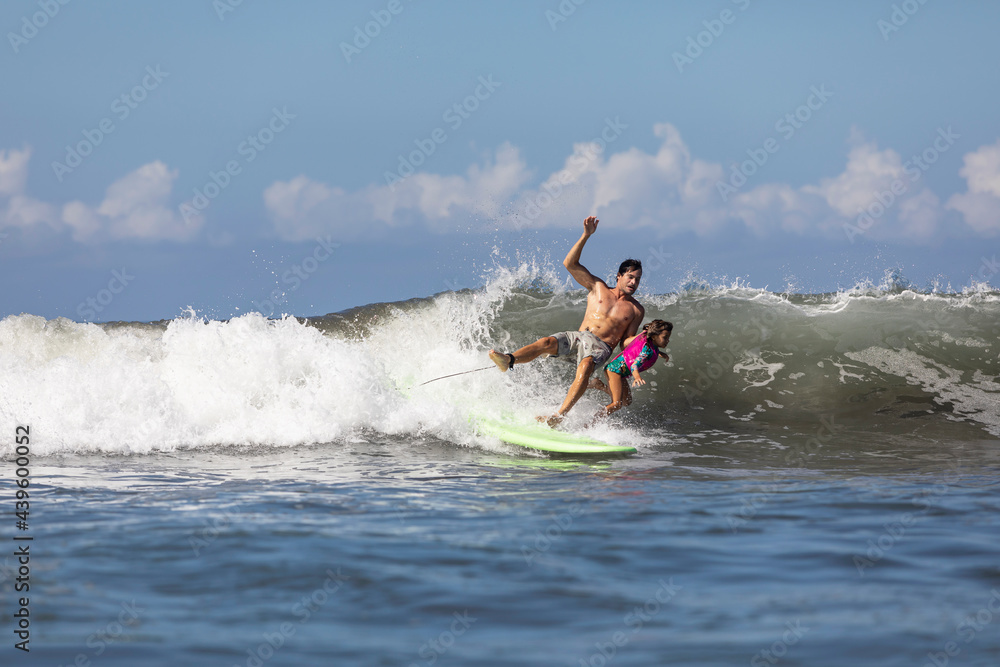 Father and daughter surfers falling in waves Father and daughter surfers falling in waves
