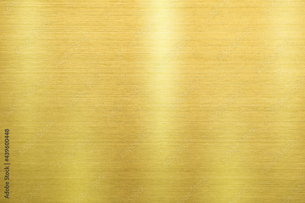 Shiny gold polished metal background texture of brushed stainless steel plate with the reflection of light. Shiny gold polished metal background texture of brushed stainless steel plate with the reflection of light.