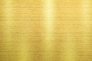 Shiny gold polished metal background texture of brushed stainless steel plate with the reflection of light.