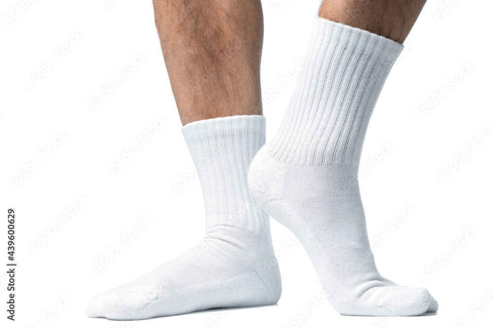 Male feet with white cotton socks on white background Male feet with white cotton socks on white background