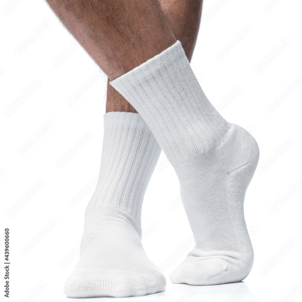Male feet with white cotton socks on white background Male feet with white cotton socks on white background