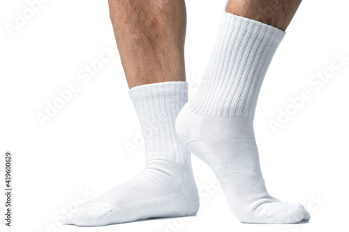 Male feet with white cotton socks on white background