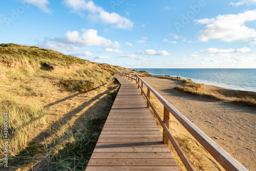 Fototapeta Naklejka Na Ścianę i Meble -  Wooden boardwalk along the North Sea coast near Kampen, Sylt, Schleswig-Holstein