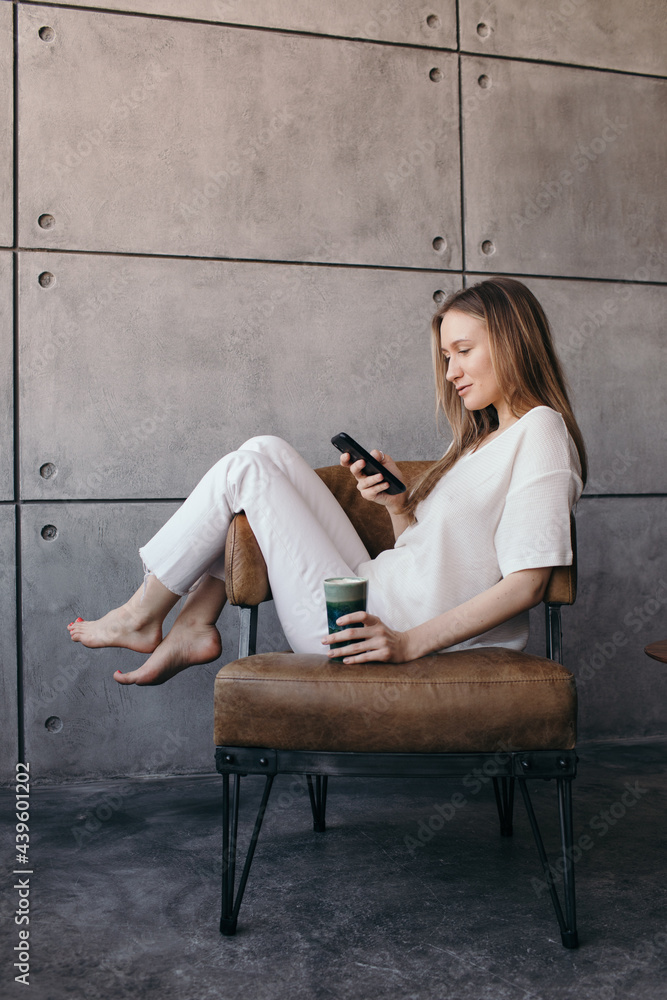 Smiling young woman surfing smartphone
Smiling young woman surfing smartphone