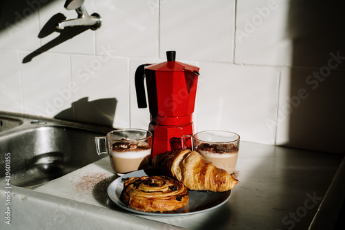 Coffe pot and sweet pastries in kitchen photo