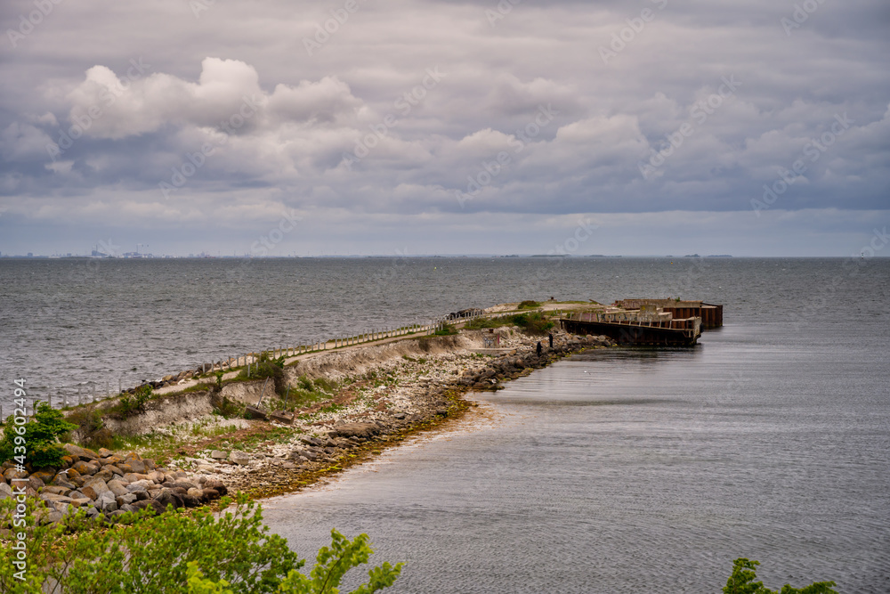 An old pier for cement boats with a beautiful, dramatic sky over the ocean