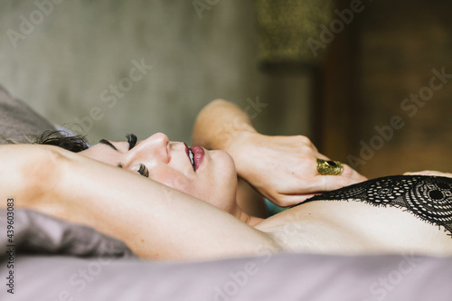 Closeup of Woman Experiencing Pleasure in Bed photo