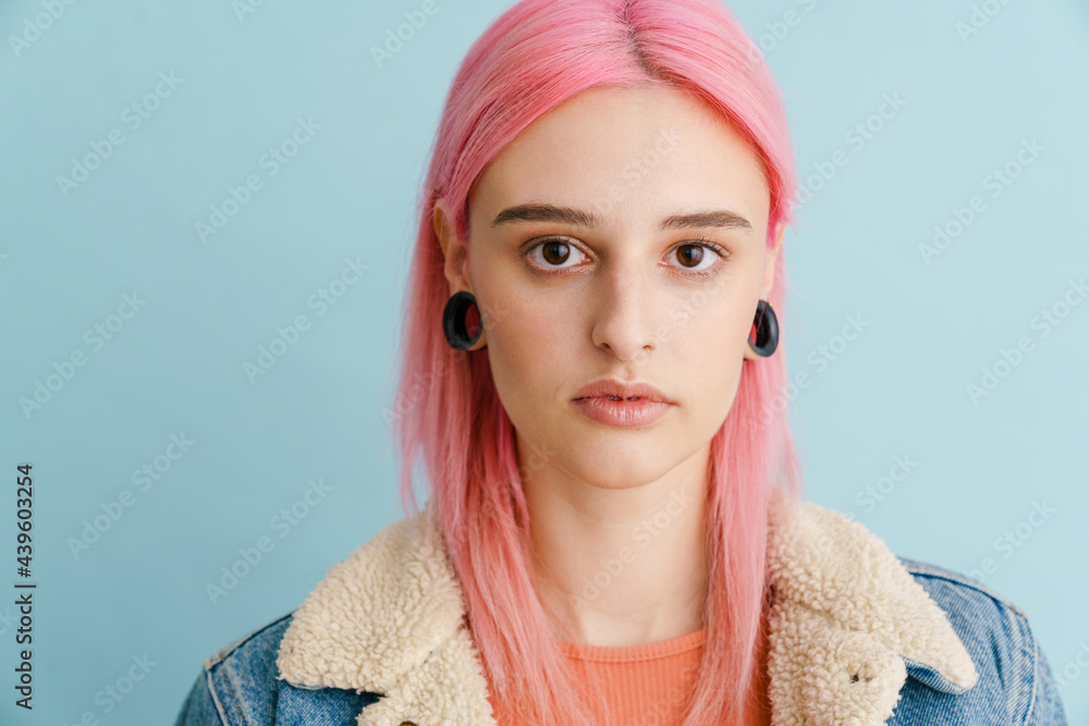 Young white woman with pink hair posing and looking at camera Young white woman with pink hair posing and looking at camera