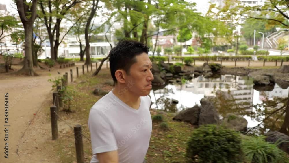 Middle-aged Japanese man exercises in a park in Tokyo Japan