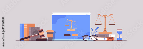 law and justice concept gavel judge books and scales on laptop screen online lawyer legal advice photo