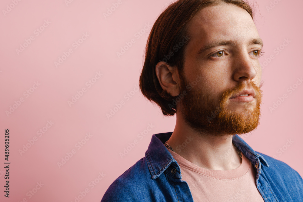 Fototapeta premium Young ginger man with beard posing and looking aside