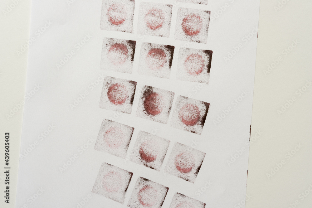 abstract background composition with reddish-black (brown) ink pad stamped loosely arranged on light background - photographed from above in a flat lay style abstract background composition with reddish-black (brown) ink pad stamped loosely arranged on light background - photographed from above in a flat lay style