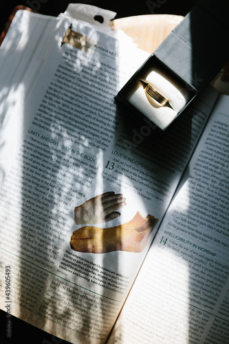 Wedding ring on book with light coming though 