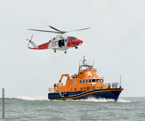 Orange sea rescue boat with rescue helicopter
