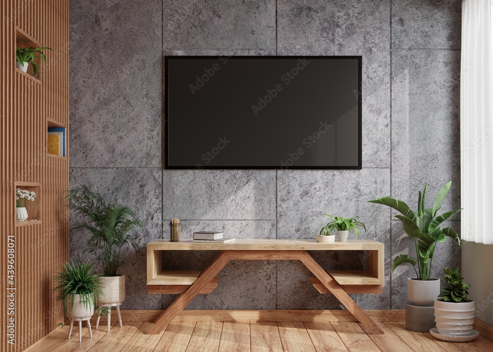 TV on a dark concrete wall in a modern living room with a wooden wall beside it And decorated with a table with plant pots on the wooden floor.3d rendering.