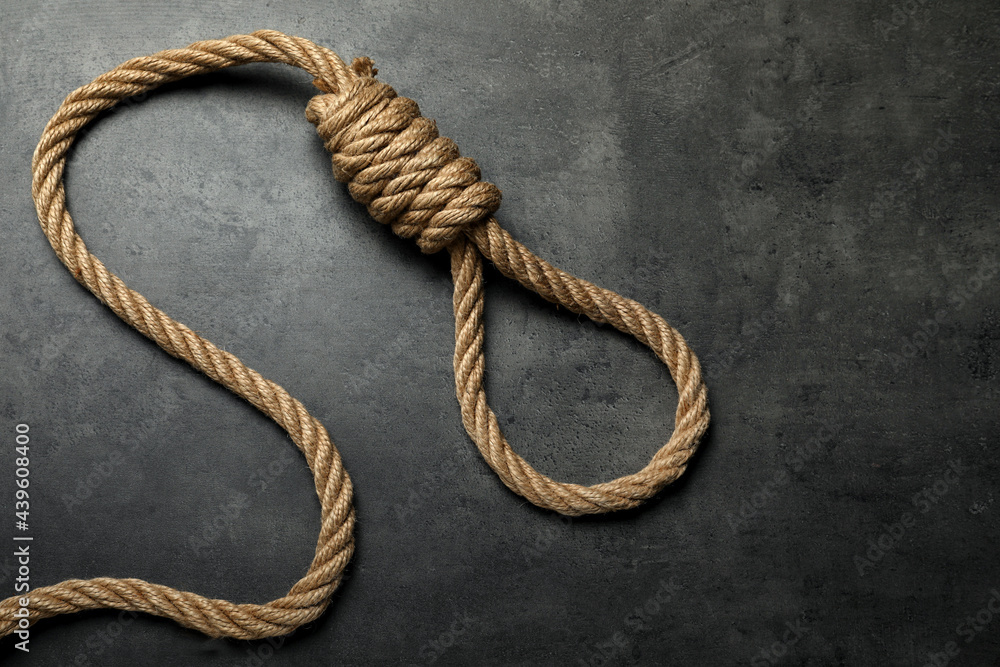 Rope noose with knot on grey table, top view. Space for text Rope noose with knot on grey table, top view. Space for text