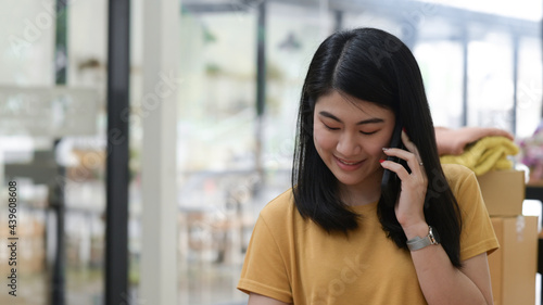 Young women talking on phone with a smiling expression.