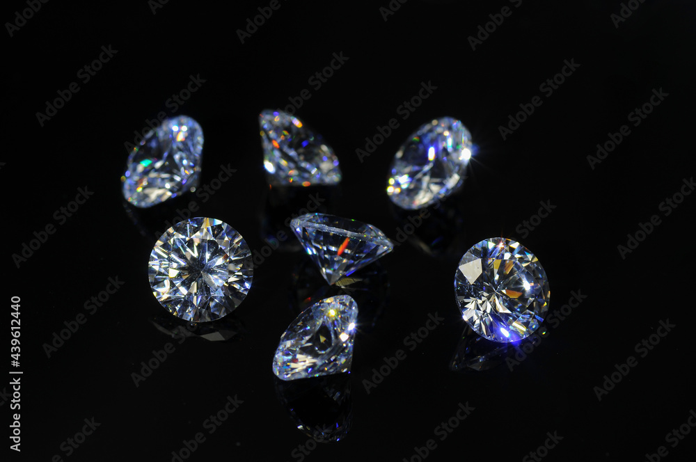 Round diamond faceted cubic zirconia set lot, cubic crystalline form of zirconium dioxide (ZrO2) colorless synthesized material. White synthetic gemstones. Diamond imitation. Black isolated background