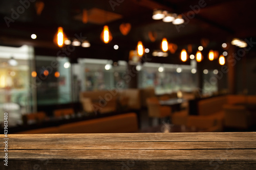 empty table to showcase your product  against a blurred coffee golden bokeh background. With panoramic windows