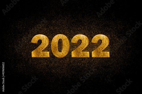 Gold numbers 2022 on black background with scattered sparkles. Horizontal New Year banner.