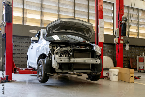 car in automobile repair service center with soft-focus and over light in the background