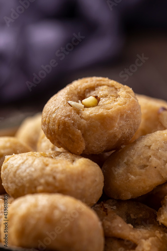 Indian traditional sweet balushahi served on a metal plate on wooden background photo