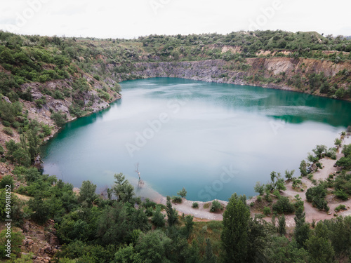 overhead top view of flooded mine lake with blue water