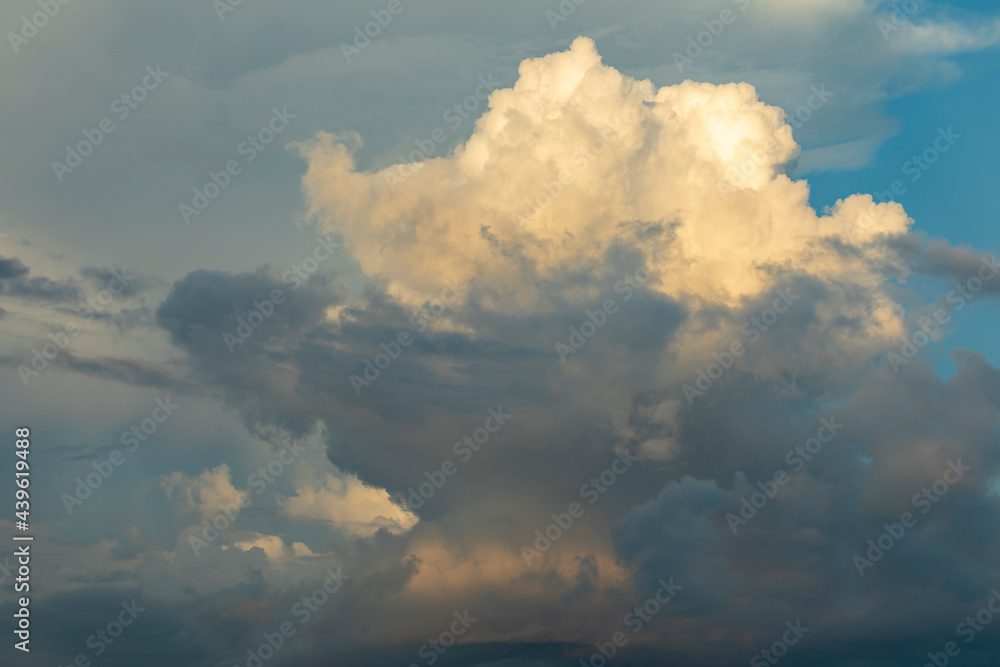 Huge storm clouds, illuminated by the last lights of the day, fill the sky at sunset, over the island of Gam, Raja Ampat, West Papua, Indonesia Huge storm clouds, illuminated by the last lights of the day, fill the sky at sunset, over the island of Gam, Raja Ampat, West Papua, Indonesia