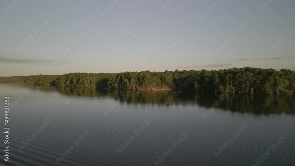 Aerial birds following view of a hige river bay under the setting sun. High quality 4k footage Aerial birds following view of a hige river bay under the setting sun. High quality 4k footage