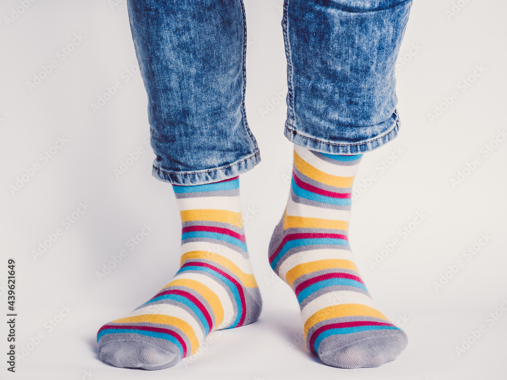 Men's legs and bright socks. Without shoes. Close-up. Style, beauty and elegance concept