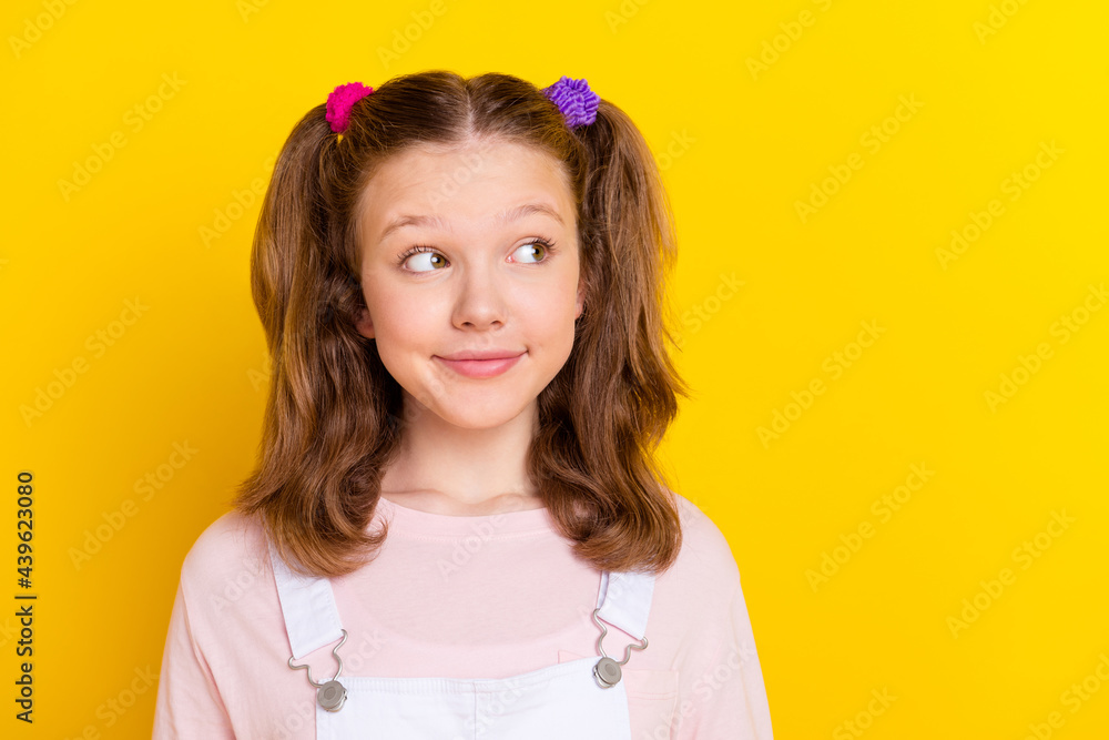 Photo portrait schoolgirl in casual clothes looking copyspace isolated bright yellow color background Photo portrait schoolgirl in casual clothes looking copyspace isolated bright yellow color background