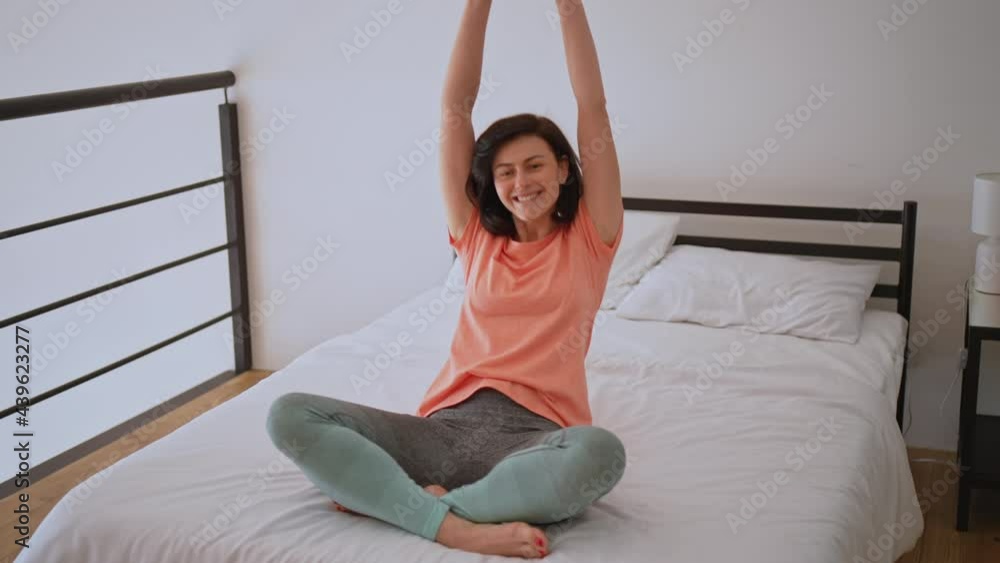 happy adult woman have fun in bedroom looking camera falls on the bed carefree joyful happy adult woman have fun in bedroom looking camera falls on the bed carefree joyful