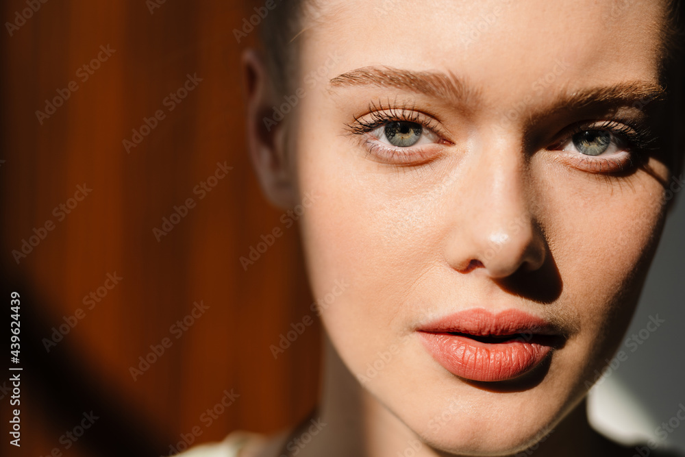 Young blonde white woman posing and looking at camera indoors Young blonde white woman posing and looking at camera indoors