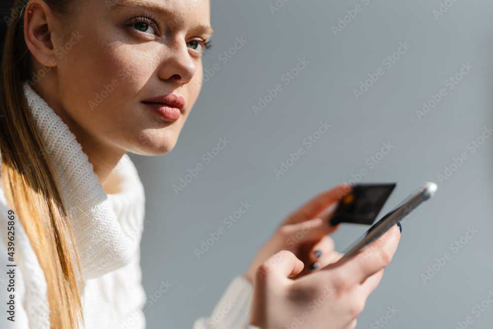 Close up of a young blonde woman shopping online Close up of a young blonde woman shopping online