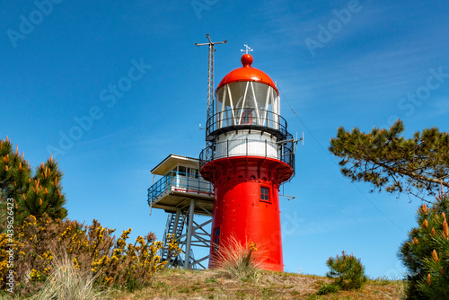 Red lighthouse on a dune at Vlieland island in the Netherlands.
