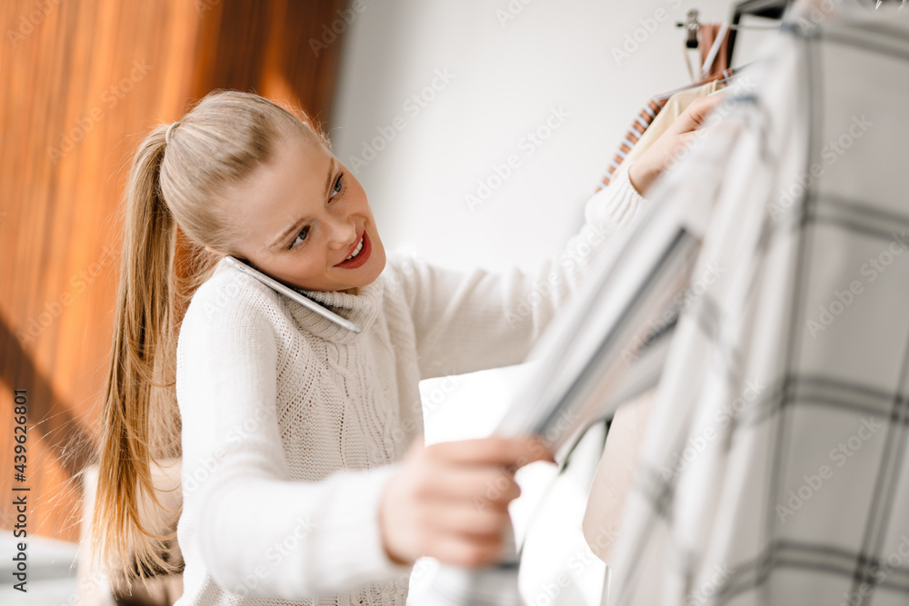 Young blonde white woman choosing clothes Young blonde white woman choosing clothes