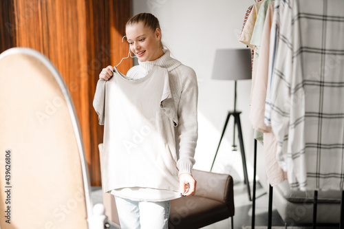 Photos Young blonde white woman choosing clothes