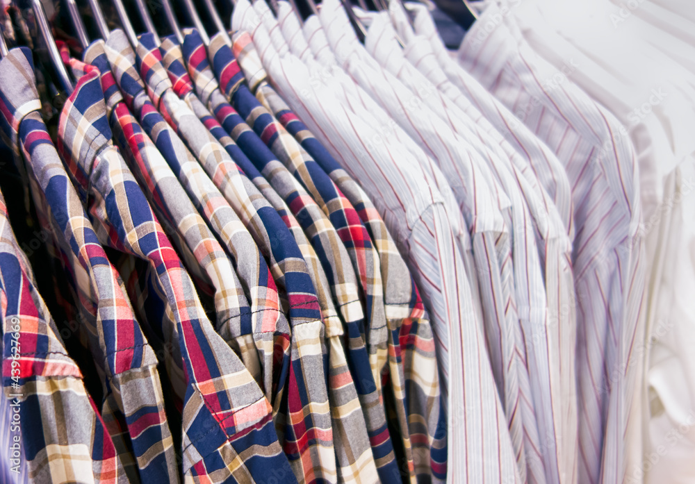 Long sleeve shirts hanging on hangers in a clothing store Long sleeve shirts hanging on hangers in a clothing store