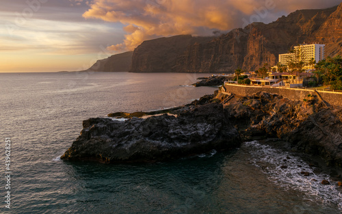 Sunset in Los Gigantes in Tenerife with view on natural swimming pool
