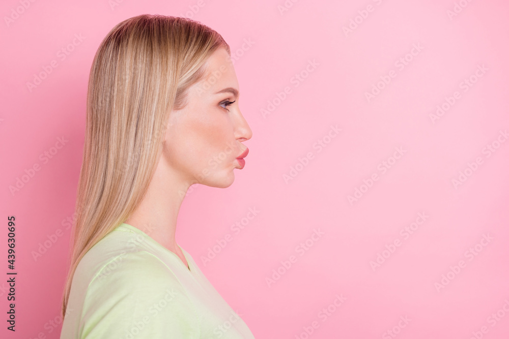 Profile photo of romantic lady look empty space blow air kiss wear green t-shirt isolated on pink background Profile photo of romantic lady look empty space blow air kiss wear green t-shirt isolated on pink background